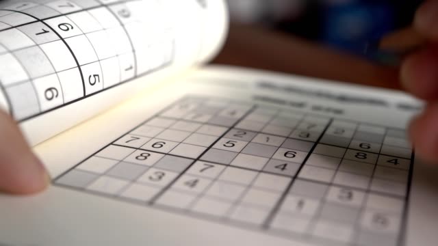 Writing on Sudoku puzzle with pencil