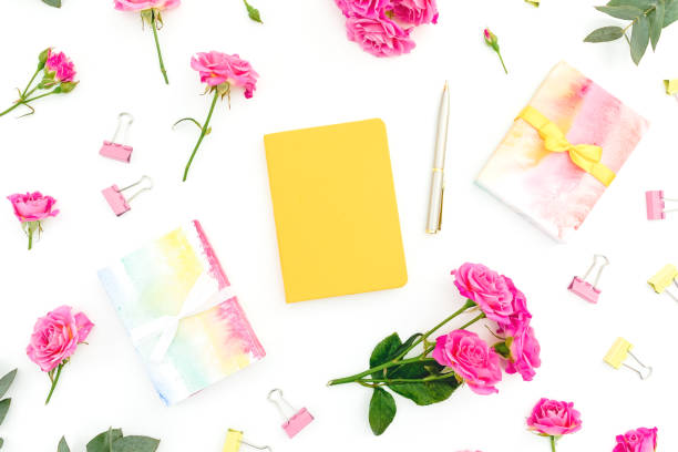 istock Female composition with notebook, gift and roses flowers on white background. Flat lay. 1248139935