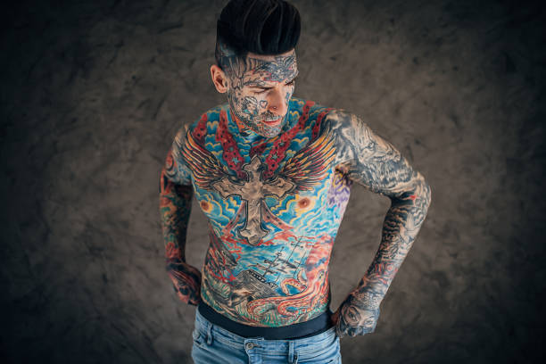 istock Shirtless man with whole body covered in tattoos 1248141747