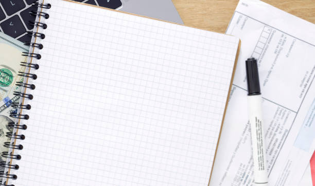 istock Blank notebook with marker and utility bills top view 1248143443