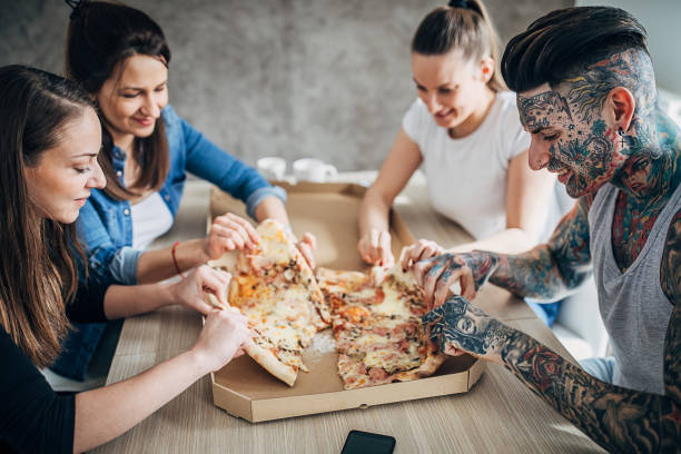 istock Group of friends eating pizza 1248148818