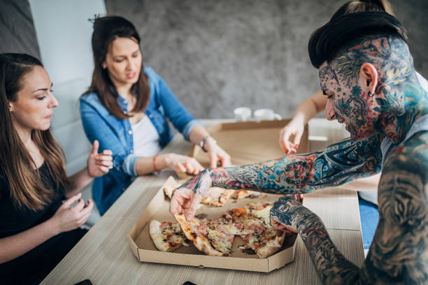 istock Group of friends eating pizza 1248148911