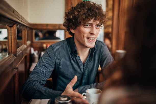 young man drinking coffee in coffee shop - couple restaurant day south america imagens e fotografias de stock