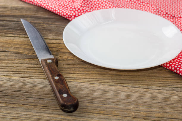 istock Table setting with red white napkin plate and knife on wooden table 1248154125