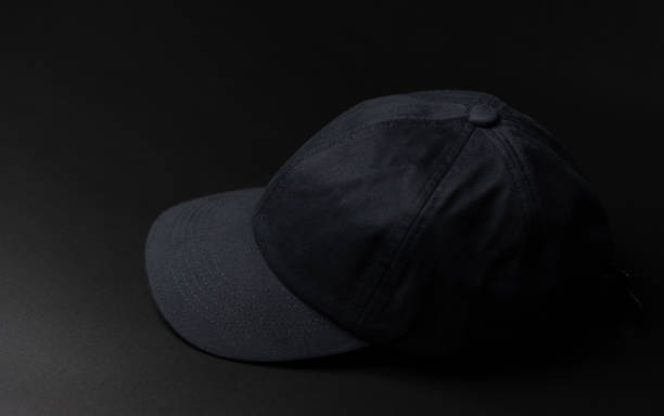 istock Black cloth cap / hat on the dark black background. 1248154306