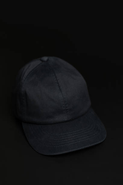 istock Black cloth cap / hat on the dark black background. 1248154319