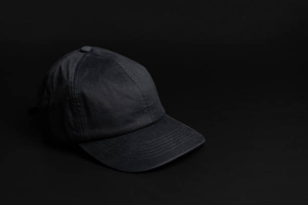 istock Black cloth cap / hat on the dark black background. 1248154324