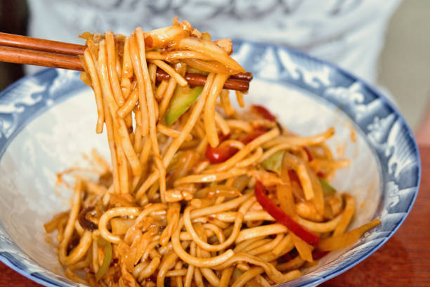 istock Chinese chicken noodles with fried vegetables 1248156683