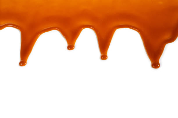 istock Background of flowing caramel sauce isolated on white. 1248156989