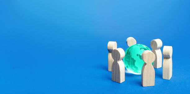 istock Blue earth globe is surrounded by people. Global communication, cooperation and collaboration. Access to the World Wide Web. Consolidation in solving global problems. Diplomacy and negotiation process 1248160814