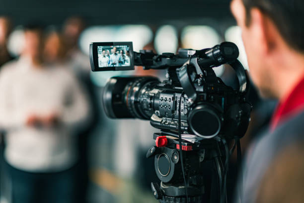 Close-Up Of Cameraman Filming In Studio  camera operator stock pictures, royalty-free photos & images