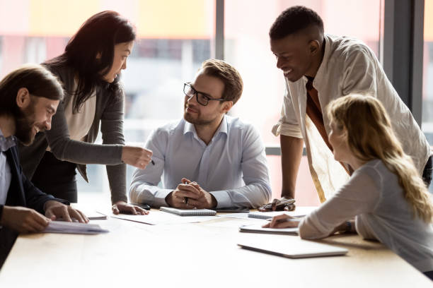 istock Boss sitting at desk listens creative ideas of multiethnic employees 1248161434