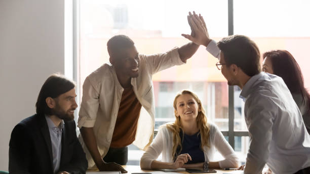 istock Multiethnic teammates giving high five sharing success during group meeting 1248161436