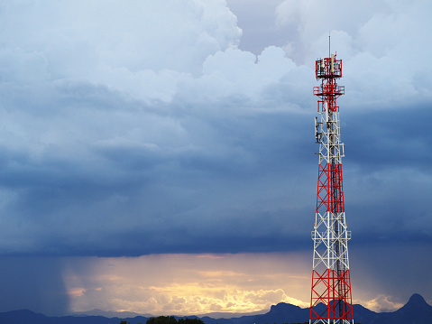 Mobile phone transmitter antenna with dramatic sky with cloud.