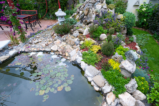 a photography of a pot with water lilies in it on the ground, cauldron of water lillies in a pot on the ground.