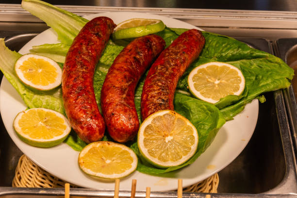 Plate of Greek loukaniko sausages with lemon.