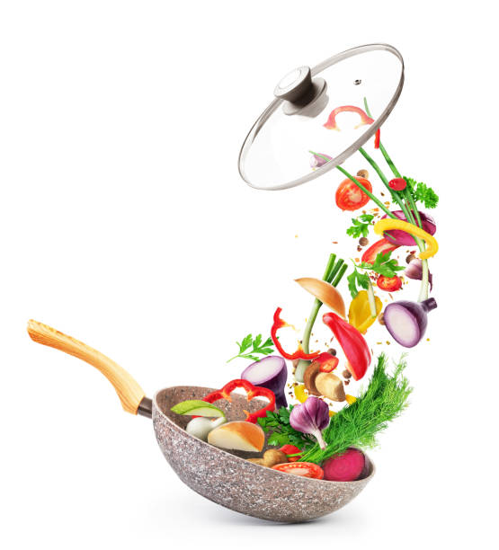 istock Cooking concept. Vegetables and bacon are falling on a pan isolated on white background. Healthy food. 1248166742