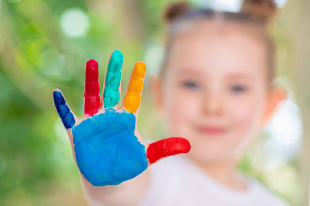 istock Little Girl featuring painted hands Concept Education, School, Creativity Favorite Focus. 1248167073