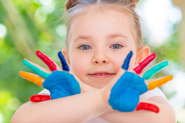 istock Little Girl featuring painted hands Concept Education, School, Creativity Favorite Focus. 1248167130