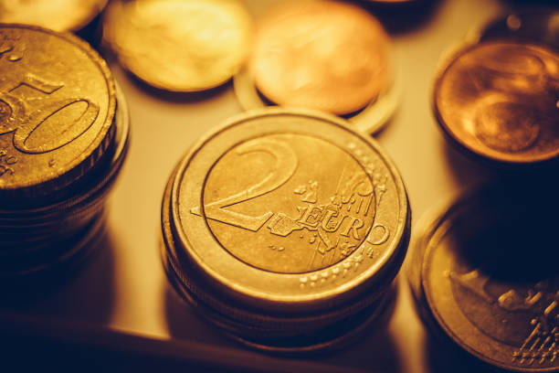 istock Stacks of iron euro coins on the dark table. 1248167458