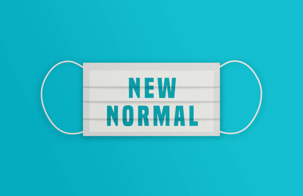 istock White Protective Mask with New Normal message over the blue background. 1248168202