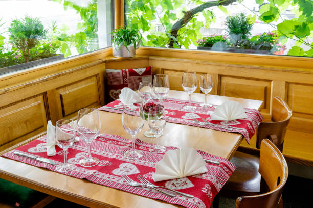 istock charming and inviting restaurant table with a bay window and grapevines behind with colorful place settings 1248168687