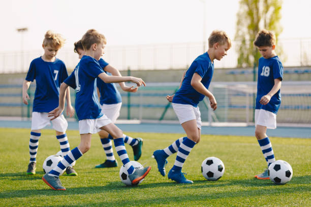 istock Boys Practicing Soccer on School Field. 10 Years Old Kids on Football Training Class. Physical Education Unit for Elementary Age School Children 1248170768