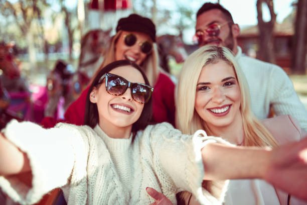 istock Friends Taking Smiling Selfie On The Carousel Ride 1248171842