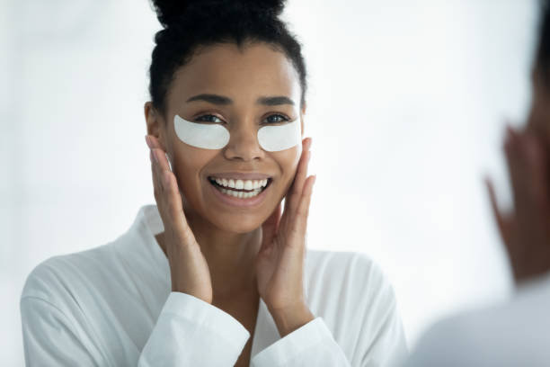 istock Mirror reflection smiling African American woman applying hydrogel eye patches 1248172124