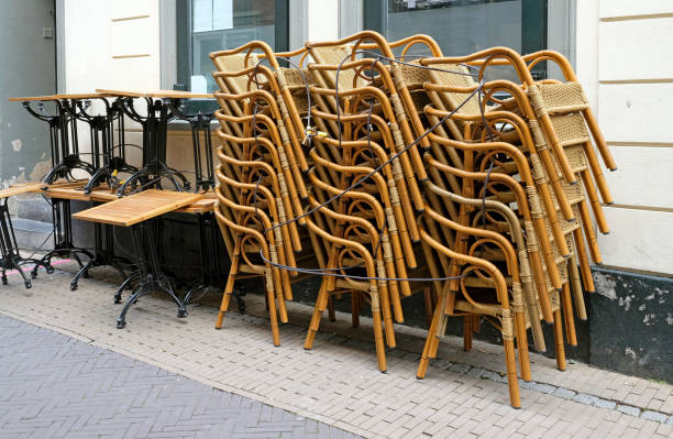 istock Stacked chairs and tables in front of a restaurant during the lockdown 1248172538