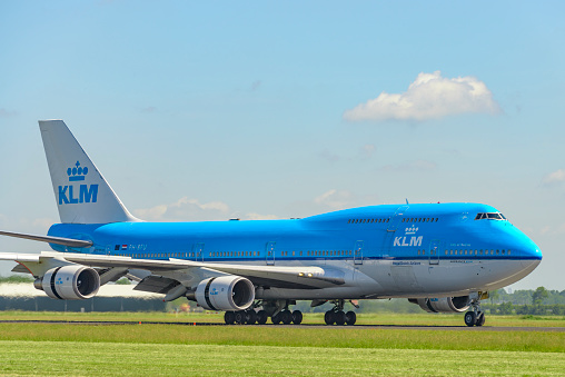 KLM Boeing 747 airplane landing at Schiphol Airport near Amsterdam in The Netherlands.