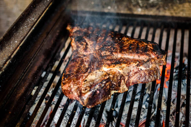 istock Grilling Big T Bone steak on natural charcoal barbecue grill. 1248173874
