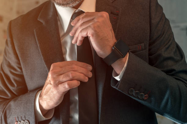 istock Businessman tying necktie knot 1248174067