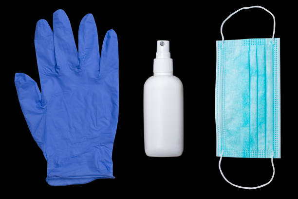 istock protection glove, alcohol sanitizer and mask on black surface 1248174344