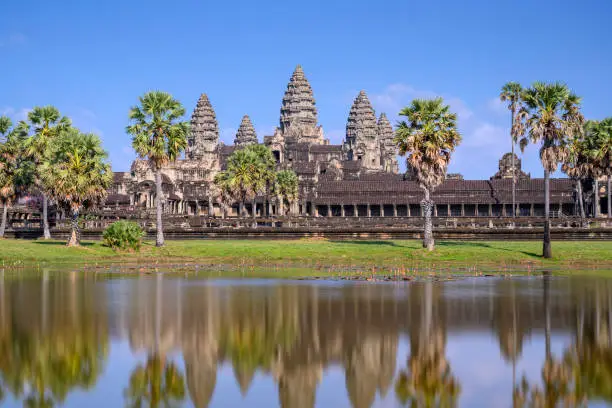 Angkor Wat (Constructed: Early-Mid 12th century, King/Patron: Suryavaman II, Religion: Hinduism)"nAngkor Wat is surrounded by a moat and an exterior wall measuring 1,300 meters x 1,500 meters. The temple itself is 1km square and consists of three levels surmounted by a central tower.