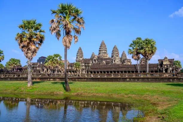 Angkor Wat (Constructed: Early-Mid 12th century, King/Patron: Suryavaman II, Religion: Hinduism)"nAngkor Wat is surrounded by a moat and an exterior wall measuring 1,300 meters x 1,500 meters. The temple itself is 1km square and consists of three levels surmounted by a central tower.