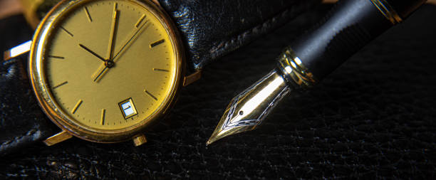 istock Fountain pen and antique watch in underexposed light 1248176981