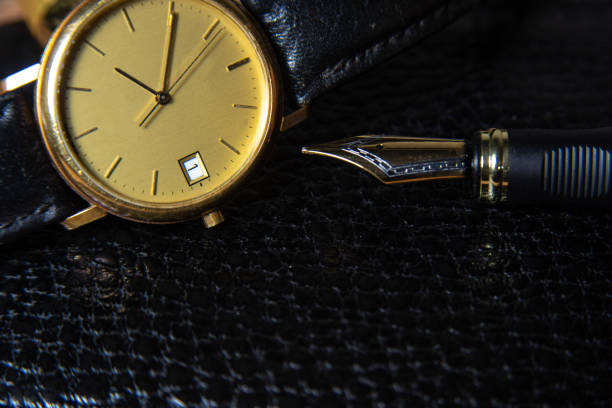 istock Fountain pen and antique watch in underexposed light 1248176985
