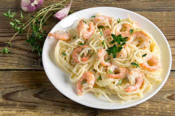 istock spaghetti with prawns in cream sauce. 1248177181