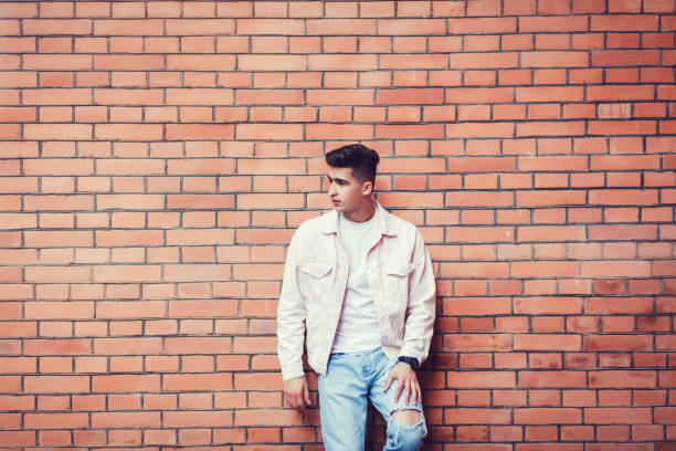 istock Stylish sexy man posing near brick 1248177414