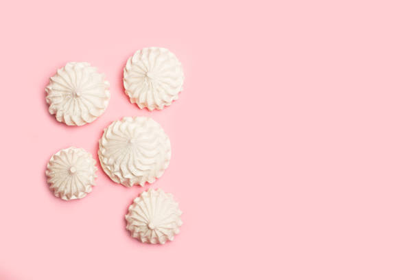istock Meringues on a pink background in a top view 1248177659