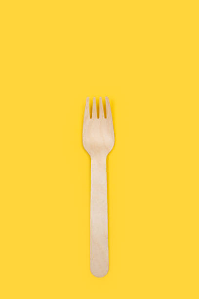 istock Wooden fork on a yellow background 1248177823