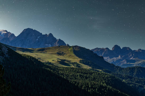 istock Starry night over Italian alps. Mountains in the moonlight. 1248178818