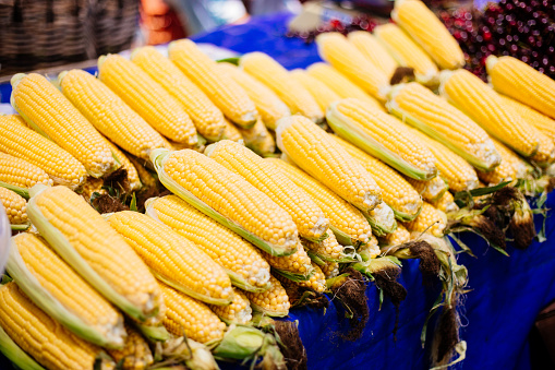 Market stall full of corncobs at local vegetable market