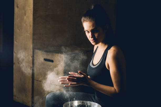 istock Female fitness model clapping hands with talc powder 1248180796