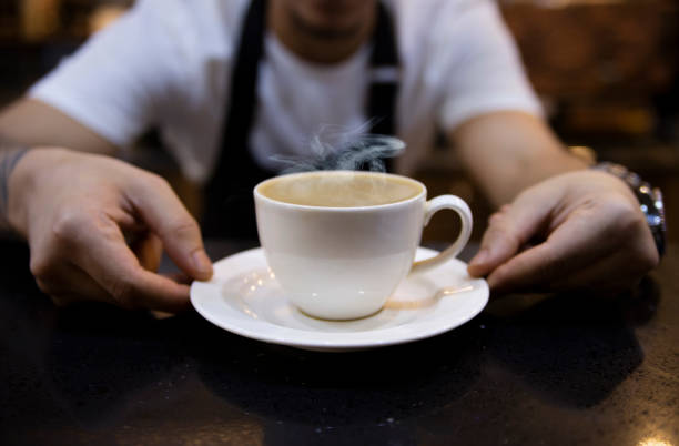 Barista serving cup of coffee