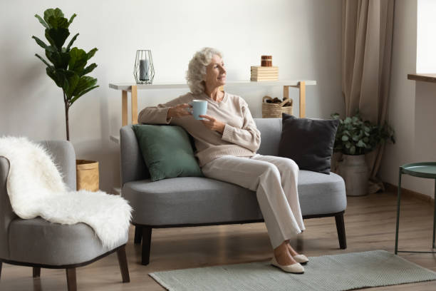 istock Smiling 60s elderly woman look in distance dreaming 1248182115