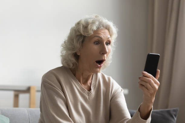 istock Elderly woman shocked by message on smartphone gadget 1248182129