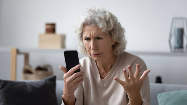 istock Angry senior woman frustrated by smartphone problems 1248182138