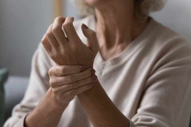 istock Close up of elderly woman check pulse on wrist 1248182165